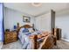 A cozy bedroom featuring a wooden bed frame, white closet doors, and a ceiling fan at 3762 S Halifax St, Aurora, CO 80013