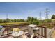 Cozy outdoor deck with dining set and grill, great for summer BBQs with green yard views under a clear sky at 3762 S Halifax St, Aurora, CO 80013