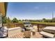 Outdoor deck with grill and seating area, perfect for entertaining with suburban views in the background on a sunny day at 3762 S Halifax St, Aurora, CO 80013