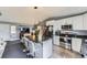 Stylish kitchen with a large island, stainless steel appliances, and open layout to the living area at 3762 S Halifax St, Aurora, CO 80013