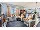 Comfortable living room with a large window, recliner seating, and open layout to the kitchen at 3762 S Halifax St, Aurora, CO 80013