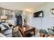 Spacious living room with a gray sofa, a large coffee table, and an exercise machine near a window at 3762 S Halifax St, Aurora, CO 80013