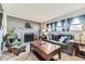 Inviting living room with a gray brick fireplace, comfortable seating, and natural lighting from multiple windows at 3762 S Halifax St, Aurora, CO 80013