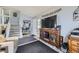 Cozy living area with stairs, front door, storage and decorative furniture, and a large TV at 3762 S Halifax St, Aurora, CO 80013