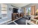 Inviting living space featuring a large TV, comfortable seating, and natural light from the window at 3762 S Halifax St, Aurora, CO 80013