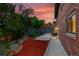 A fenced backyard with red mulch, a concrete patio, and a brick exterior at 6205 Pierce St, Arvada, CO 80003