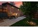 The brick house features a patio, a grassy yard, and privacy fencing at 6205 Pierce St, Arvada, CO 80003