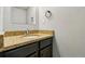 A close-up shows a vanity with a granite countertop and brushed nickel faucet at 6205 Pierce St, Arvada, CO 80003