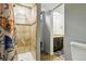 Bathroom with tiled shower stall, decorative shower curtain, vanity with dark cabinets at 6205 Pierce St, Arvada, CO 80003