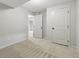An empty bedroom features neutral paint, plush carpet and two white doors at 6205 Pierce St, Arvada, CO 80003