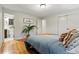 Serene bedroom with hardwood floors, ensuite bathroom, and ample closet space at 6205 Pierce St, Arvada, CO 80003