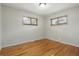 Empty bedroom featuring hardwood floors and windows, providing natural light and a calming ambiance at 6205 Pierce St, Arvada, CO 80003