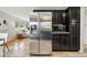 Bright kitchen with stainless steel refrigerator, dark cabinets, and modern appliances at 6205 Pierce St, Arvada, CO 80003