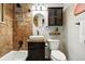Charming bathroom with brown-tiled shower, modern sink, and elegant vanity at 6205 Pierce St, Arvada, CO 80003