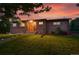 Charming brick home with lovely landscaping, wooden accents, and a well-manicured lawn at 6205 Pierce St, Arvada, CO 80003