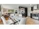 Open-concept kitchen, dining area and living room with stainless steel appliances and fireplace at 6205 Pierce St, Arvada, CO 80003
