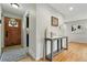 Welcoming entryway with hardwood floors, stylish console table, and attractive front door at 6205 Pierce St, Arvada, CO 80003