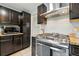 Close-up of a well-equipped kitchen with modern appliances and dark cabinets, perfect for cooking at 6205 Pierce St, Arvada, CO 80003
