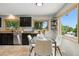Kitchen with dark cabinets, a stainless steel dishwasher, and a window overlooking the neighborhood at 6205 Pierce St, Arvada, CO 80003
