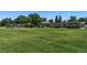 Expansive green space at the park with lush grass, mature trees, and recreational facilities at 6205 Pierce St, Arvada, CO 80003
