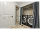 A laundry closet reveals a modern washer and dryer behind a stylish curtain at 6205 Pierce St, Arvada, CO 80003