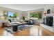 Cozy living room with fireplace, neutral decor, and abundant natural light at 6205 Pierce St, Arvada, CO 80003