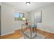 Cozy bedroom with hardwood floors, bright natural light, and a decorative desk at 6205 Pierce St, Arvada, CO 80003