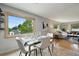 Dining area features modern table setting and sunlit view, with an open floor plan at 6205 Pierce St, Arvada, CO 80003