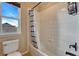 Well-lit bathroom featuring a tiled shower and a window offering plenty of natural light at 23593 E Eads Dr, Aurora, CO 80016