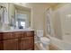 Bright bathroom featuring a brown vanity, ceramic tile flooring, shower over tub with a white shower curtain at 23593 E Eads Dr, Aurora, CO 80016