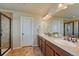 Bathroom with double sinks, granite countertops, and a tile shower at 23593 E Eads Dr, Aurora, CO 80016