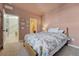 Cozy bedroom featuring plush carpet, a floral-themed bedspread, and access to the bathroom and foyer at 23593 E Eads Dr, Aurora, CO 80016