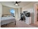 Neutral bedroom with natural light, fan, bed, and modern desk featuring gaming setup and extra shelving at 23593 E Eads Dr, Aurora, CO 80016
