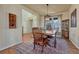 Elegant dining room featuring hardwood floors, a classic wooden table with chairs, and a decorative china cabinet at 23593 E Eads Dr, Aurora, CO 80016