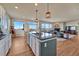 Open-concept kitchen with a large island, stainless steel appliances, and seamless flow to the living area at 23593 E Eads Dr, Aurora, CO 80016
