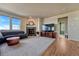Inviting living room with hardwood floors, a cozy fireplace, and large windows that offer an abundance of natural light at 23593 E Eads Dr, Aurora, CO 80016