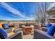 Outdoor patio area with a brick fire pit and comfortable seating, perfect for enjoying the cool weather and scenic views at 23593 E Eads Dr, Aurora, CO 80016