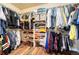 Spacious walk-in closet with ample shelving, hanging rods, and hardwood floors, offering generous storage solutions at 23593 E Eads Dr, Aurora, CO 80016