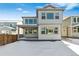 Back of house showing gray siding, lots of large windows, covered patio and fenced backyard at 16651 W 93Rd Ave, Arvada, CO 80007