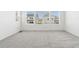 Empty bedroom with carpet and three sunny windows at 16651 W 93Rd Ave, Arvada, CO 80007