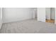 Spacious bedroom with neutral carpet and trim and a doorway to the ensuite bathroom at 16651 W 93Rd Ave, Arvada, CO 80007