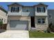 Charming two-story home with a stone facade, attached garage, and well-manicured lawn at 16651 W 93Rd Ave, Arvada, CO 80007