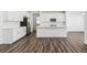 Modern white kitchen with stainless steel appliances, a center island, and sleek countertops at 16651 W 93Rd Ave, Arvada, CO 80007