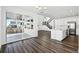 Bright open-concept living space features hardwood floors, white walls, and a sliding glass door to a patio at 16651 W 93Rd Ave, Arvada, CO 80007