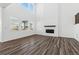 Spacious living room featuring modern finishes, a fireplace, and large windows at 16651 W 93Rd Ave, Arvada, CO 80007