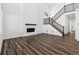 Bright living room with a fireplace and modern staircase at 16651 W 93Rd Ave, Arvada, CO 80007