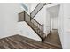 Carpeted staircase with wooden railing leading to the second floor at 16651 W 93Rd Ave, Arvada, CO 80007