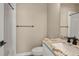 Bathroom featuring single sink vanity with granite countertop and modern shower with glass door at 888 S Valentia St # 102, Denver, CO 80247