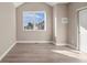 Bright bedroom featuring light wood floors, neutral paint and a large window with exterior views at 888 S Valentia St # 102, Denver, CO 80247