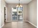 Bright dining area with modern lighting and access to an outdoor balcony with black metal railings at 888 S Valentia St # 102, Denver, CO 80247